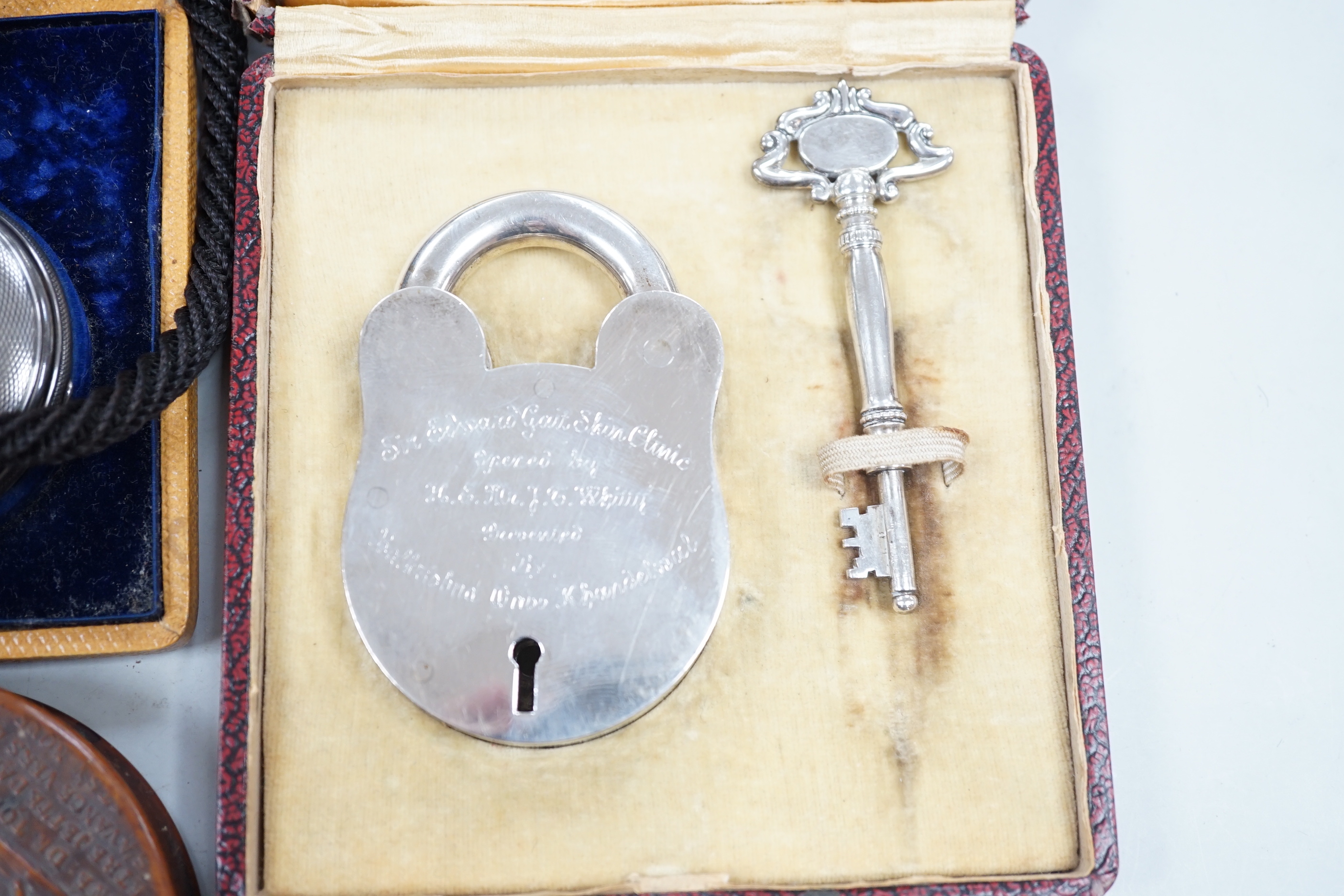 A group of 19th century and later collectibles to include a silver plated presentation padlock and key, a silver hunter pocket watch, french snuff box, etc.